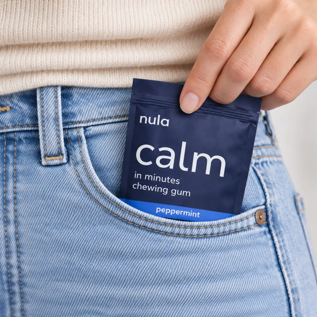 a pouch of nula calm gum slipped into a jeans pocket